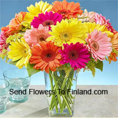 25 Mixed Colored Gerberas With Some Ferns In A Glass Vase