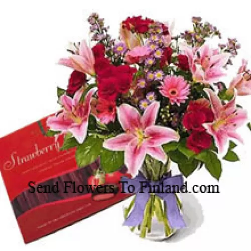 Assorted Flowers In A Vase And A Box Of Chocolate